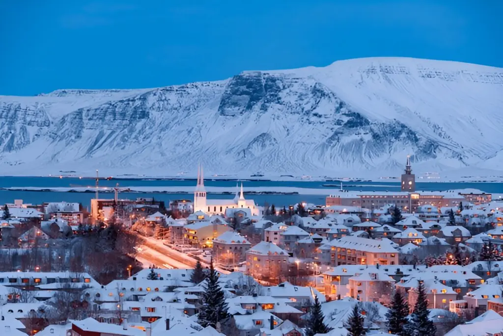Snow-covered resort below snowy mountains