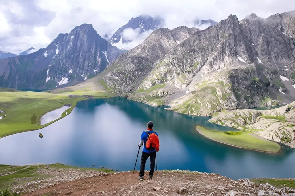 Trekker beside an alpine lake