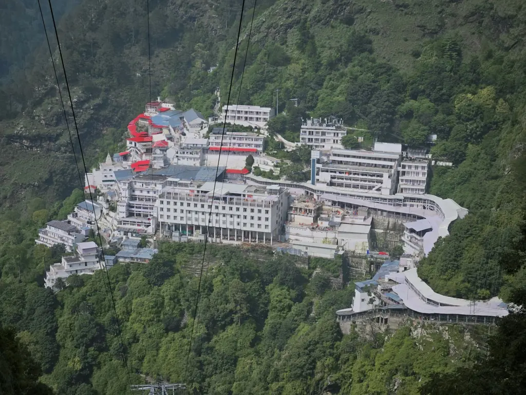 Temple complex of the Vaishno Devi Bhawan on a green mountainside above Katra